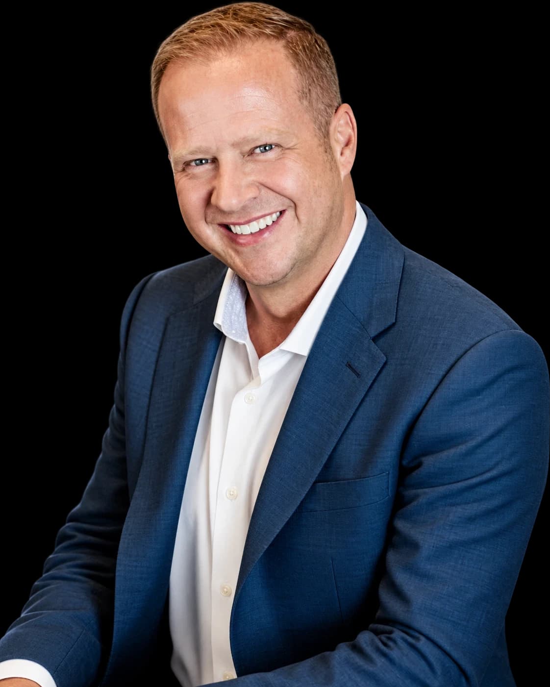 Jeremy Young, smiling, in a blue blazer